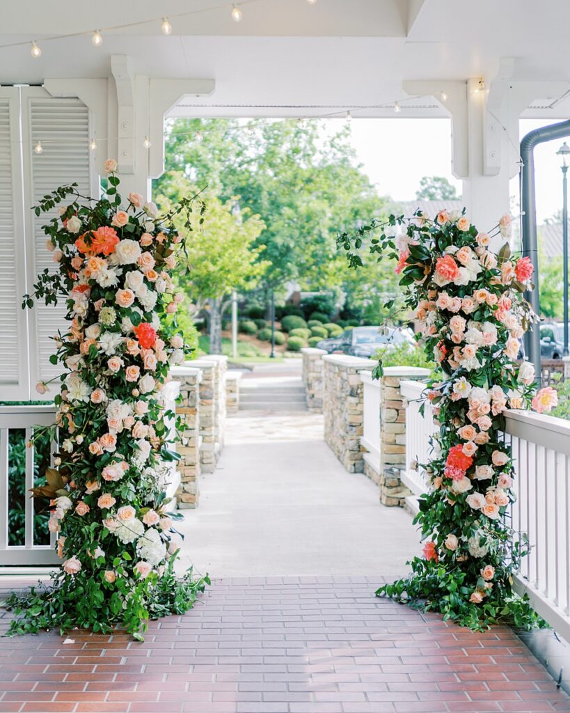 The entrance to the ceremony site at Augusta Country Club is adorned with a flower arch. 