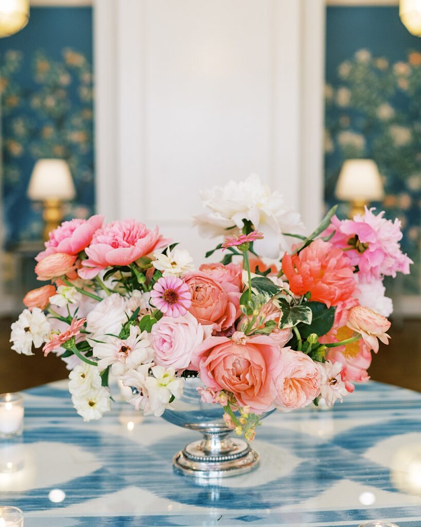 Beautiful colorful flowers sit on a table at a wedding.