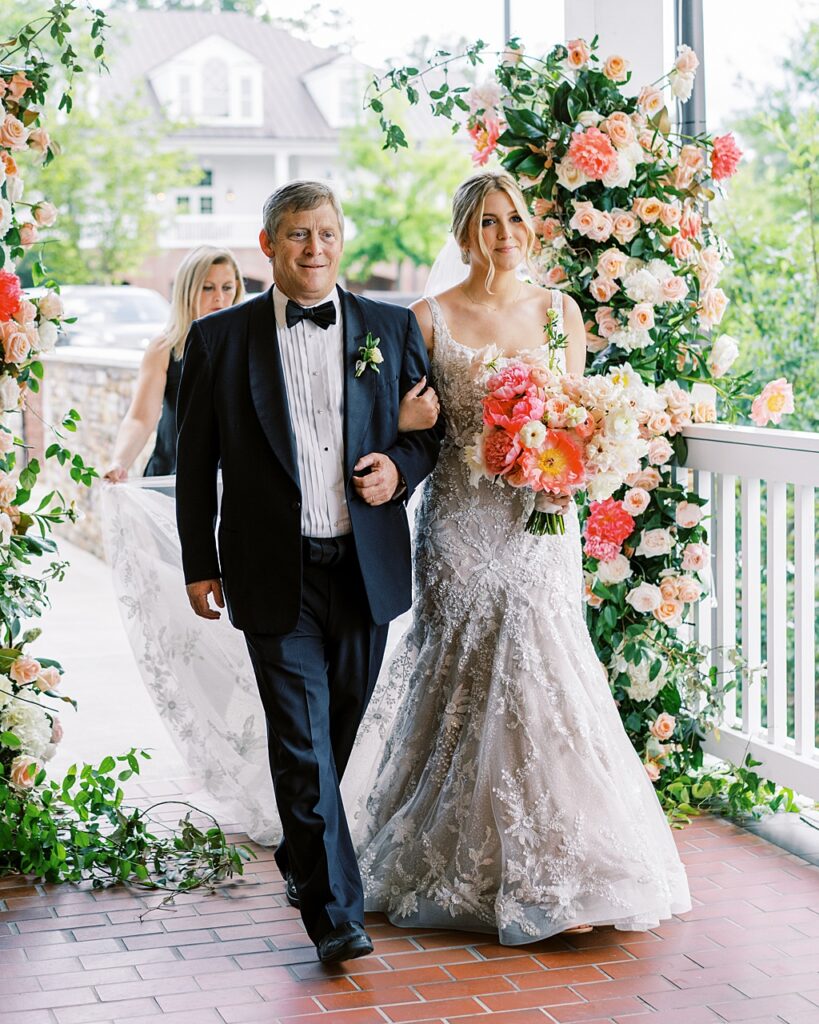 A dad walks her daughter down the aisle.

