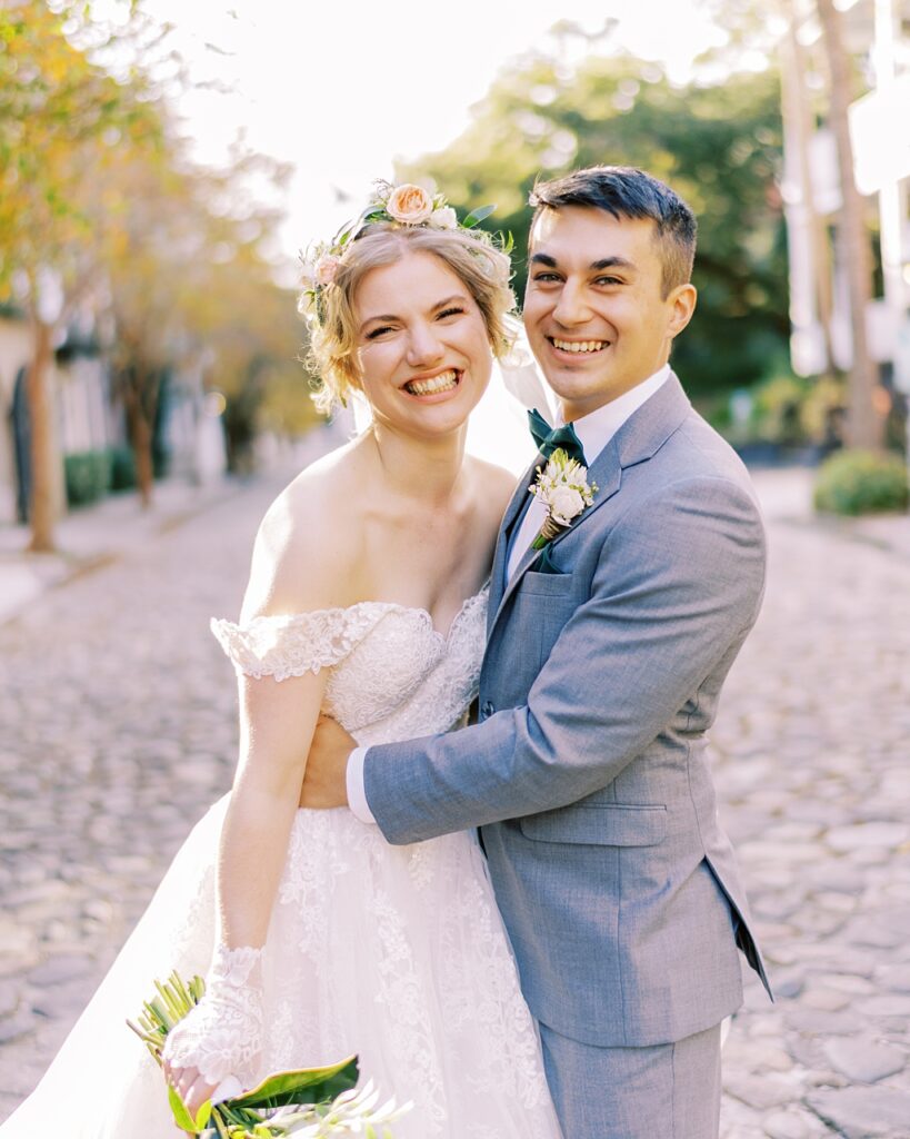 Bride and groom smiling in downtown Charleston
