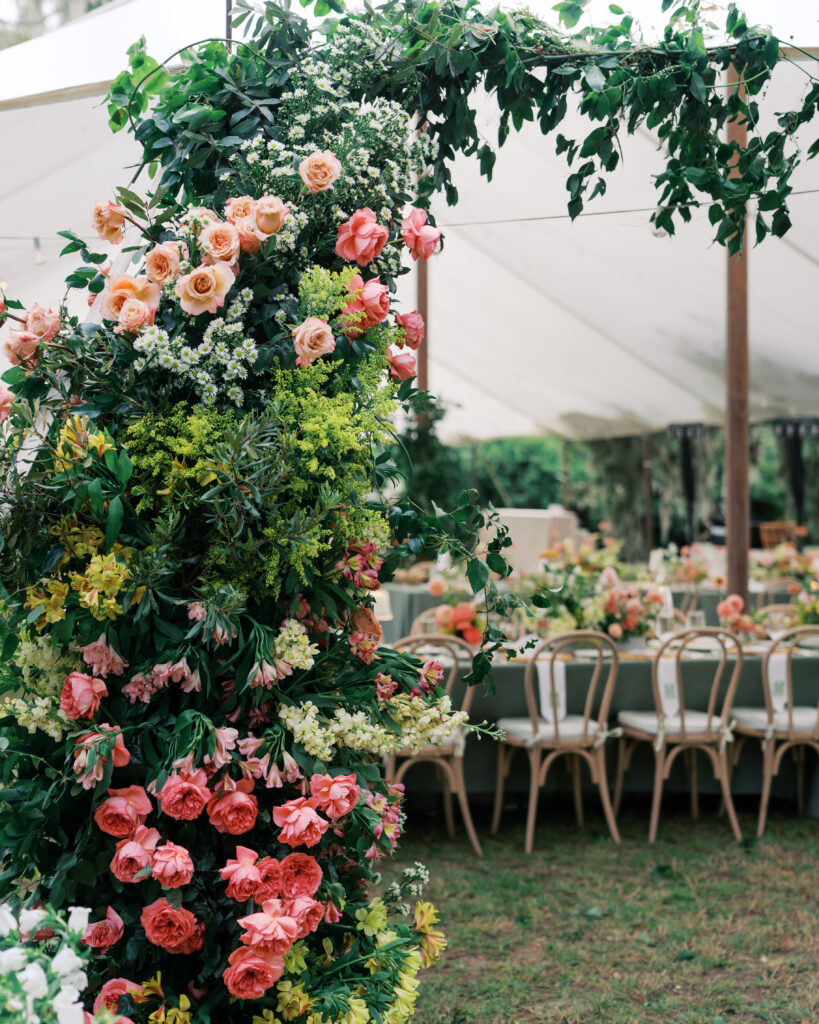 Large floral arrangement at entrance of wedding reception space