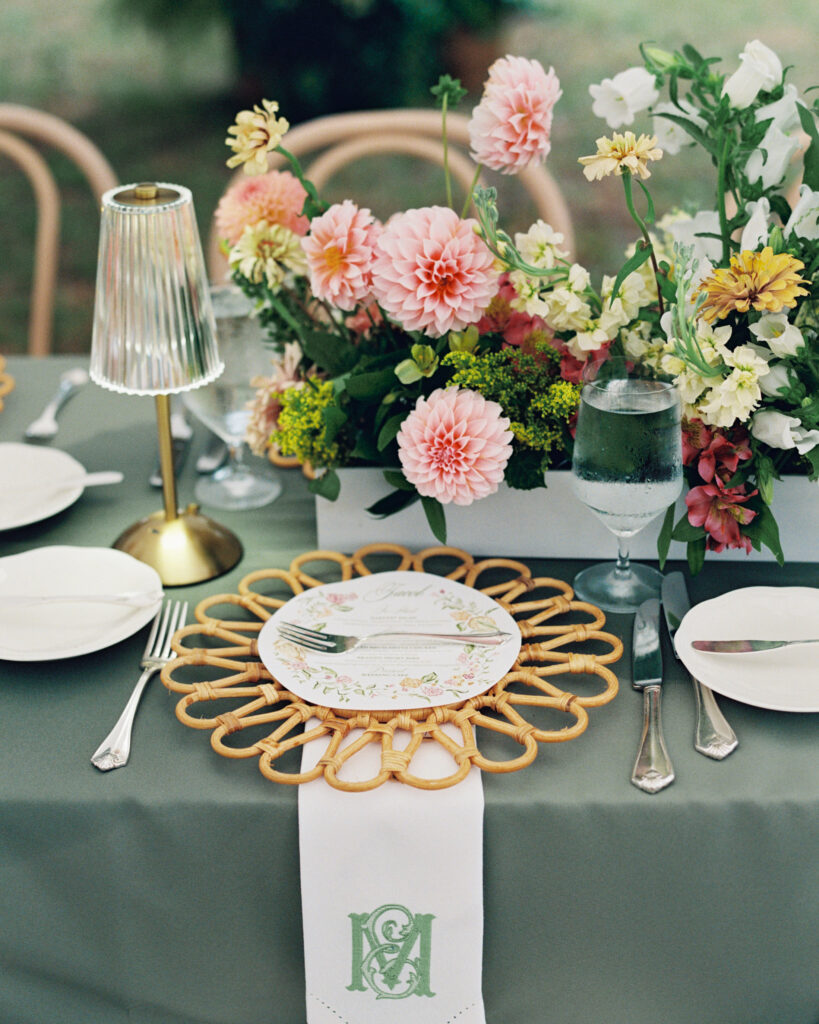 Place setting at wedding with rattan chargers
