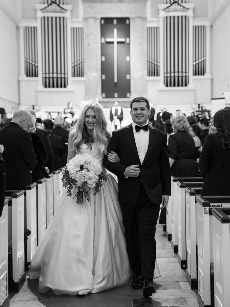 Couple walk back down aisle after getting married