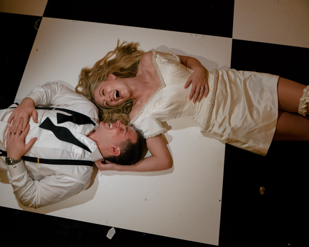 A couple laying on the dance floor at Houstonian Club