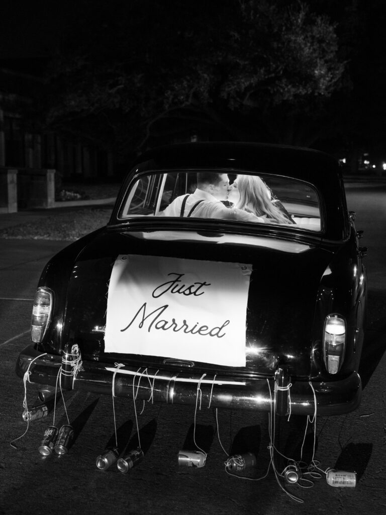 A car with "just married" on the back of it in front of the Houstonian Club