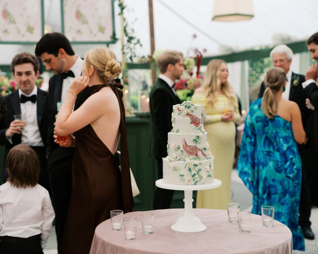 Cocktail hour guests mingling around the displayed wedding cake in Charleston, South Carolina. 